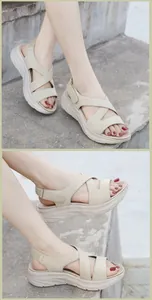 Detail view of beige platform sandals with criss-cross straps and adjustable velcro strap