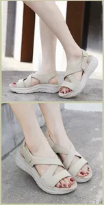 Detail of beige platform sandals featuring elastic cross straps and adjustable velcro strap