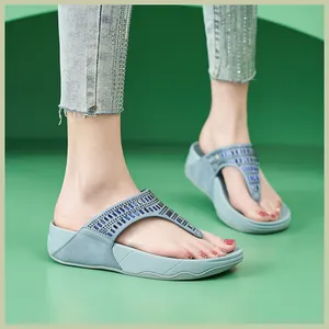 Detalle macro de sandalias de cuña para mujer adornadas con pedrería y lentejuelas azul claro