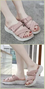 Detail view of pink platform sandals with adjustable hook-and-loop straps and wavy sole