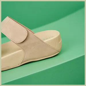 Detail of beige athletic sandal featuring double stitching and SIKE branded footbed