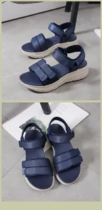 Detail of navy blue sporty sandals with velcro straps and cushioned thick soles