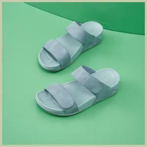 Close-up of mint green platform sandals with soft suede straps and ergonomic footbed