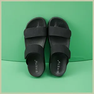 Detail view of black double-strap slide sandals with anti-slip textured footbed