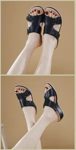 Detalle de sandalias negras con plataforma y doble hebilla sobre un fondo cálido