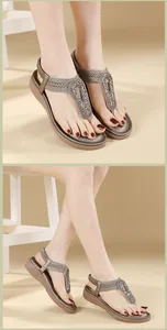 Detailed close-up of Bohemian T-strap sandals with metallic shield and weaved strap
