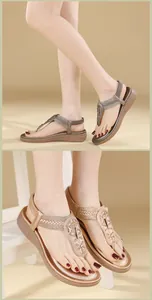 Detailed close-up of Bohemian flat sandals featuring shiny rhinestones and elastic heel straps