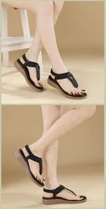 Detail of black thong sandals featuring beaded T-strap and comfortable wedge soles