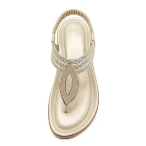 Sandali bassi bohémien color champagne dorato con cinturini intrecciati ed elastico