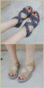 Detail of woven elastic crisscross straps on ethnic style flat summer sandals