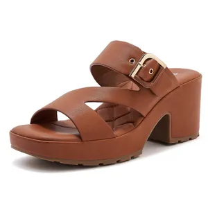 Detail of brown platform sandal with gold buckle and diamond quilted footbed