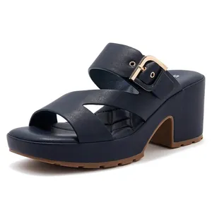 Detail of navy platform sandal featuring gold buckle and quilted faux leather insole