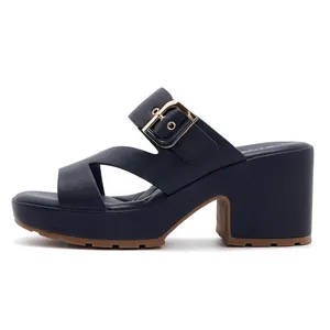 Detail view of navy blue platform sandal with gold metal buckle and thick high block heel
