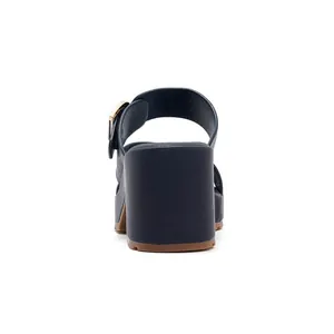 Detail of navy leather platform sandal featuring a steady block heel and gold buckle