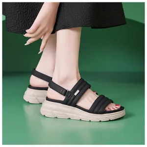Close-up of black platform sandals with quilted straps and non-slip beige soles