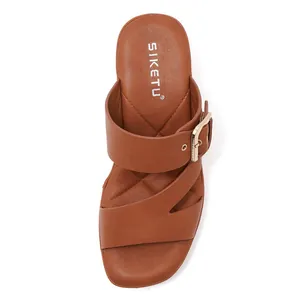 Detailed top view of brown sandals featuring multi-strap design and gold buckle hardware