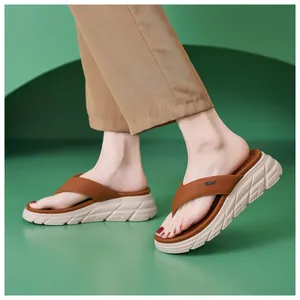 Detail view of brown platform flip-flops with leather texture and non-slip wavy sole