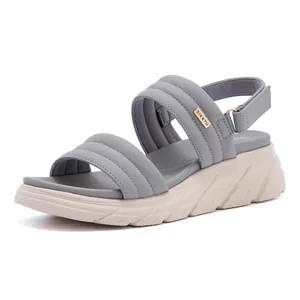 Detailed side view of grey platform sandals with thick non-slip soles and velcro straps