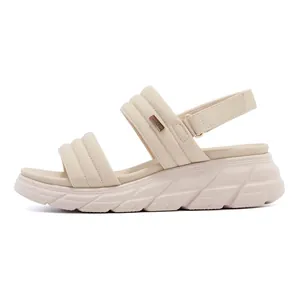 Detail view of beige padded straps and thick anti-slip platform sole on women's sandals