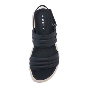 Overhead view of platform sandals with quilted black straps and beige anti-slip footbed