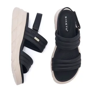 Detail view of platform sandals with black padded straps and adjustable velcro heel