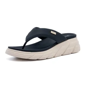 Detail of wedge flip flops with blue leather strap and metallic gold brand buckle