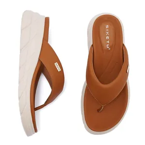 Detail view of brown platform flip-flops showing anti-slip white EVA sole and metal buckle