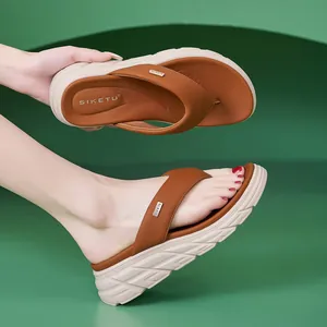Women's brown platform flip-flops with thick off-white anti-slip sole and leather texture