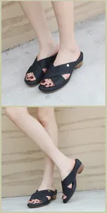 Detail of women's black wedge sandals featuring rhinestone cross straps and gold buckle