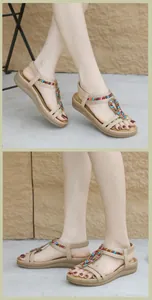 Detail of bohemian sandals with colorful beadwork and comfortable elastic heel strap