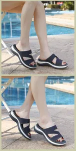 Detail view of navy blue platform wedge sandals with rhinestone crisscross straps