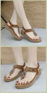 Detail of bohemian T-strap sandals with colorful beads and elastic heel strap