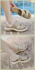 Detail of beige platform slides with rhinestone strap and chunky wedge sole outdoors