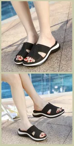 Close-up of black rhinestone platform wedge sandals by a poolside during summer