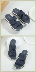 Detail view of navy blue wedge sandals with sparkling rhinestones and platform sole