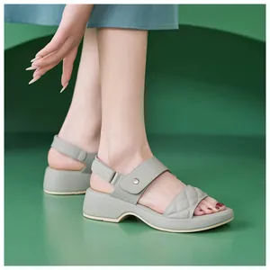 Detail view of light green quilted platform sandals with an adjustable velcro heel strap
