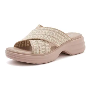 Detail of wedge sandals with breathable perforated insole and knit crisscross straps