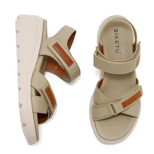 Dettaglio di sandali con zeppa verde oliva con cinturini in velcro e suola platform antiscivolo