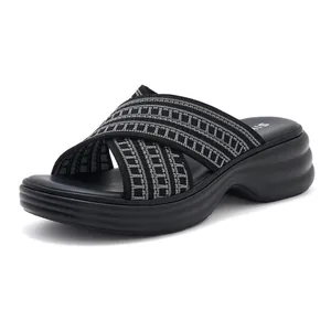 Detail of black cross-strap platform wedge sandals with grey geometric knit texture