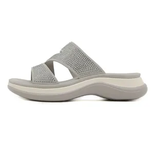 Women's light grey platform slides with rhinestone criss-cross straps and ergonomic soles