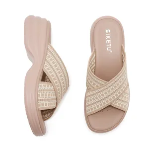 Macro detail of breathable knit cross straps on women wedge platform slide sandals