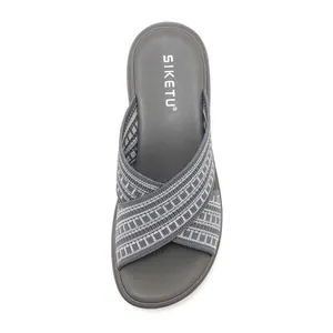 Close-up of dark grey cross-strap knitted slippers with ergonomic cushioned footbed