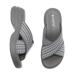 Detail view of grey knit platform wedge slide sandals with woven pattern by SIKETU