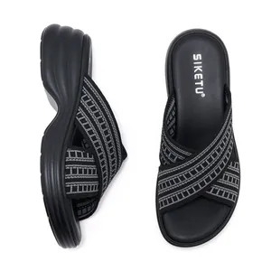 Detailed view of woven criss-cross straps and platform sole on casual wedge slide sandals