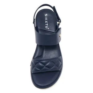 Top view of navy blue wedge sandals featuring quilted straps and a soft footbed cushion