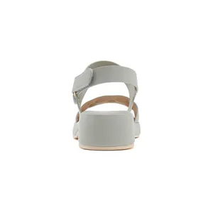 Detail view of the pale green wedge heel and adjustable velcro strap on casual sandals