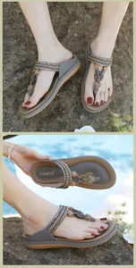 Detail of bohemian gray thong sandals featuring intricate braided straps and rhinestone hearts