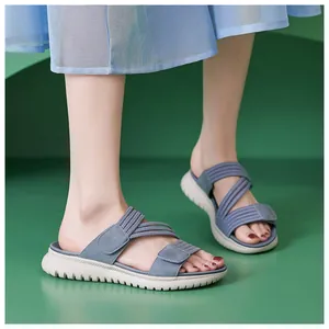 Blauwe sportieve sandalen met elastische banden en dikke golfzolen gedragen door model