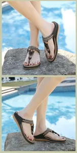 Detail view of bohemian flip flops featuring ethnic beaded straps and floral decorations