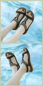 Detail of black bohemian flat sandals with intricate beading and braided straps for summer